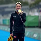 Flora Duffy, a former Buff, holds her Olympic Gold medal