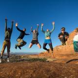 CU's hiking club jumps at the top of a hike