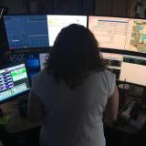  A dispatcher stands in front of a screen.