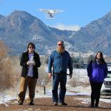 researchers flying a drone
