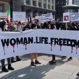 People holding a Woman, Life, Freedom sign in protest