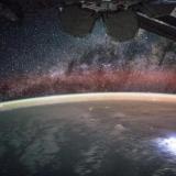 An image taken from the International Space Station shows orange swaths of airglow hovering in Earth’s atmosphere