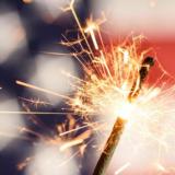 Sparkler in front of American Flag.