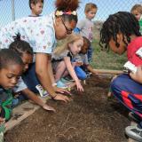 Kids work in a garden on Earth Day