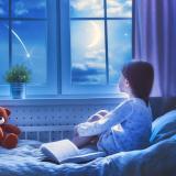 Illustration of child watching the stars from her bed
