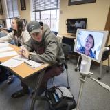 Student Annie Miller joins class remotely via Kubi robotic device 