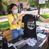 Students in masks selling Sko Buffs t-shirts