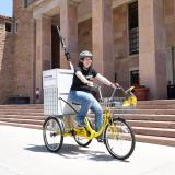 Woman on library bike in front of Norlin Library