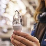 person holding a small LED lighbulb