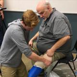 Max Armstrong performs prosthetic socket fitting