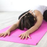 Woman stretches on yoga mat during meditation session