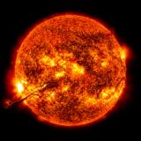 A filament of ultra-hot, ionized gas, or "plasma," leaps off the surface of the sun.