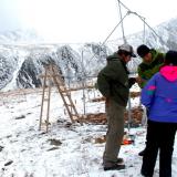 Three research collect data on a snowy Niwot Ridge.