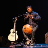 Okaidja Afroso performing on stage