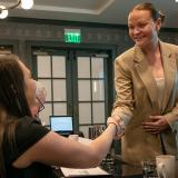 Adelyn Dozier, right, shakes hands with one of the judges from Omni Interlocken