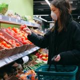Stock image of a person wearing a face mask in a supermarket