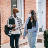 Students talking while walking outside and wearing masks