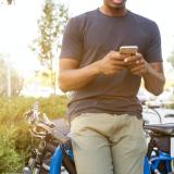 Person checks phone next to bike rack