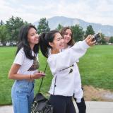 Friends pose for a selfie on campus