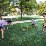 students playing a game outside while wearing masks