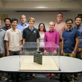 CU Boulder students and faculty display their QB50 micro satellite