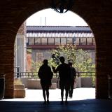 Students walking through UMC arch