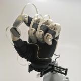 A prosthetic hand with fingertip sensors installed.