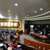 Panelists speak during a conference in Wolf Law