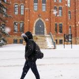 Student walks on snowy campus