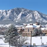 Snowy campus building with Flatirons in the background