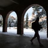 person walking on snowy campus