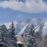 Snowy Flatirons and campus building