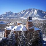 Old Main on a snowy day with Flatirons in the background