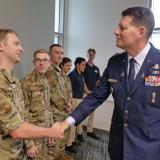 Gen. Thompson shakes hand with an ROTC cadet in fatigues