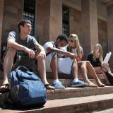 Students sitting on the steps of Norlin Library