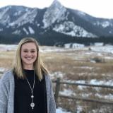 Integrated physiology major Kelsey Sheehan poses in front of Flatirons