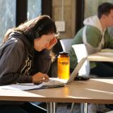 Student studying at laptop on campus