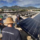 CU staff members install solar panels on campus