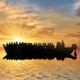 Silhouette of people on a boat at sea