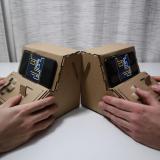 people playing with Tinycade cardboard controllers