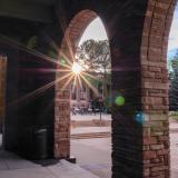 The sun sets, casting rays over the UMC loggia space. 