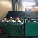 Students pose for photo in recycling bins at Vail Resorts