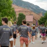 students in matching Buffs shirts walking on campus