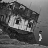 A house in India tipping precariously into the Ganges River