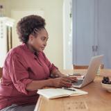 A woman sitting at a laptop