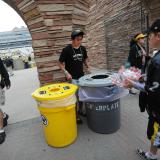 Students help fans sort their recyclables and compostables at a CU football game.