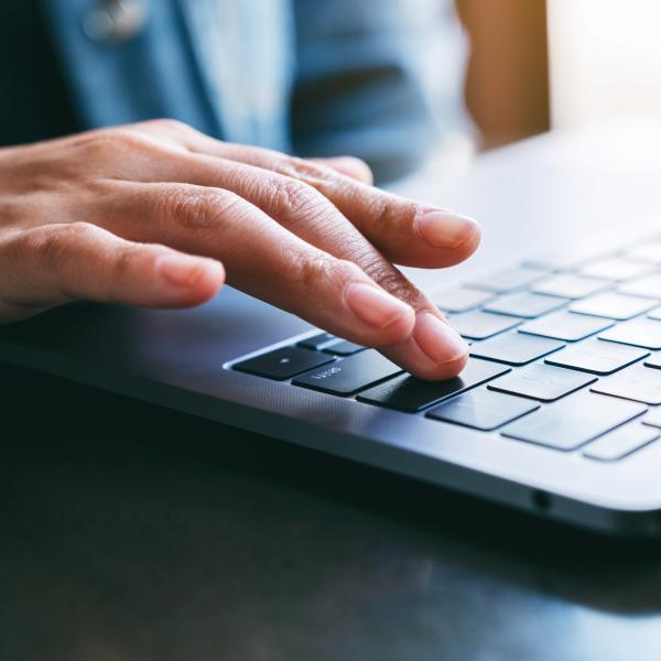 person typing on laptop