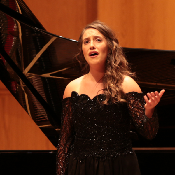 Student singing on stage