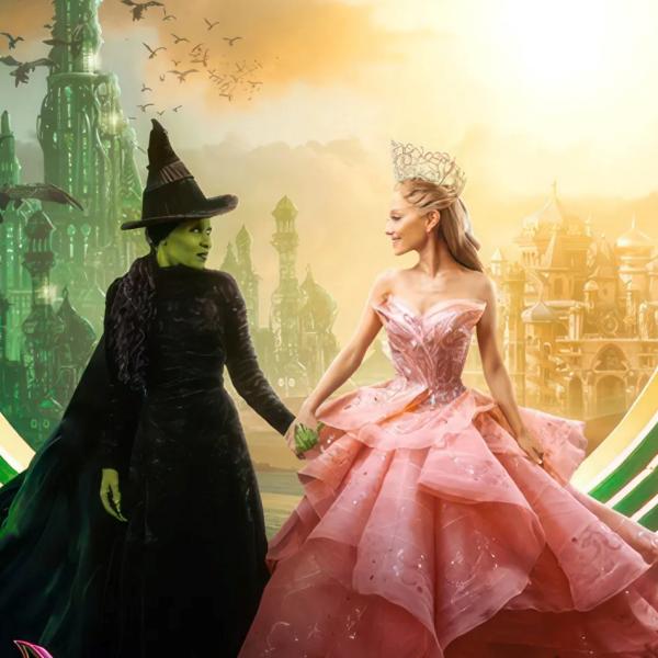 A person in a black witch costume and a person in a pink princess costume face each other