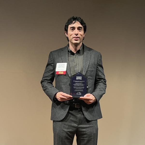 Matt Mendoza with award in hand